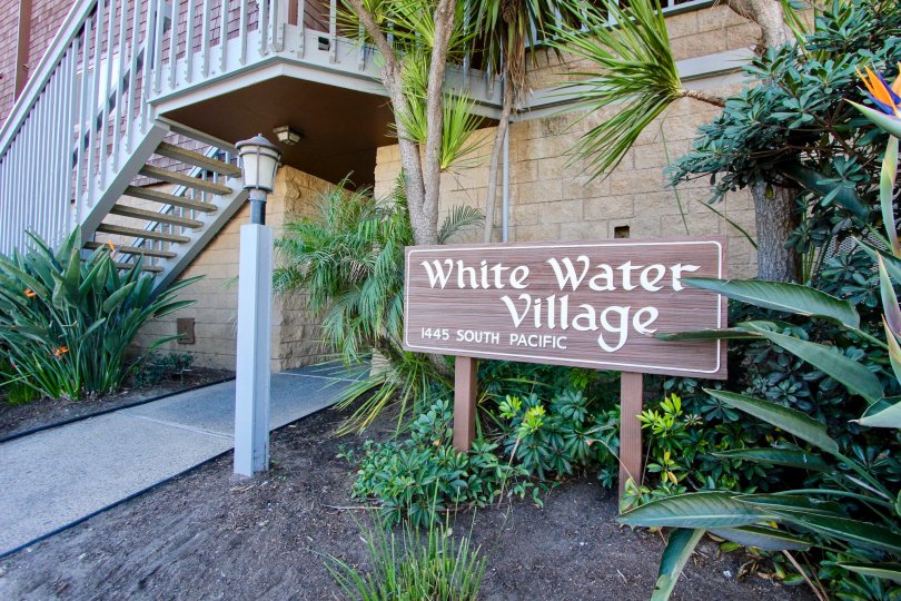 Wooden sign with white paint for White Water Village in Oceanside, CA