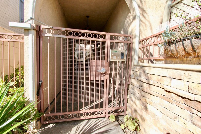 A gated entrance to the Crown Morrell community painted in pink color.