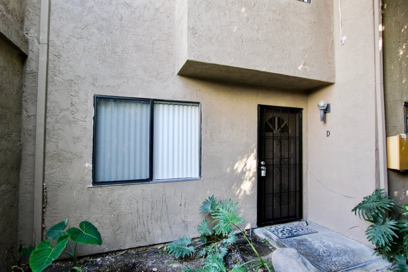 A residental looking building with one window and one door pictured in pacific View Townhomes.