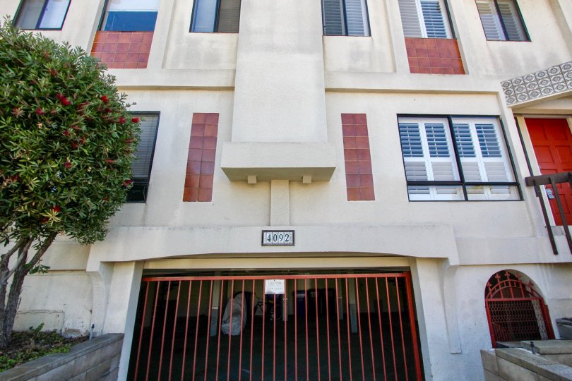 a big building with white paint and red doors with garage entrance in the front in Riviera Cove