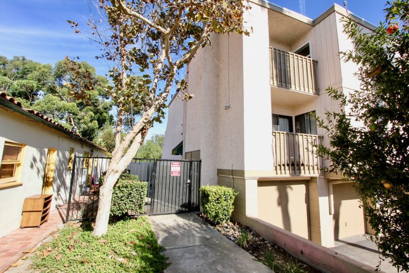 A gated side entrance beside a Two-storey residence in Rose Creek community.
