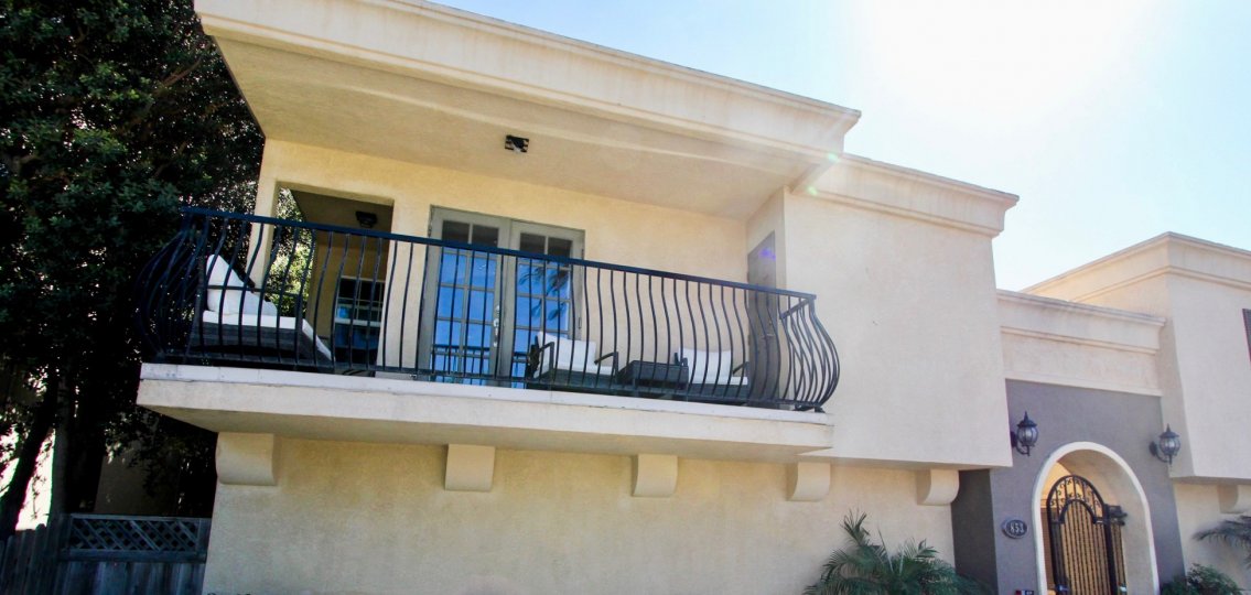 A beautiful building balcony side with tree in the Thomas Avenue Condominiums.