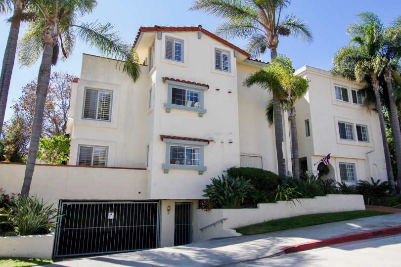 A three story white condominium with underground parking in Point Loma CA at La Playa Blanca