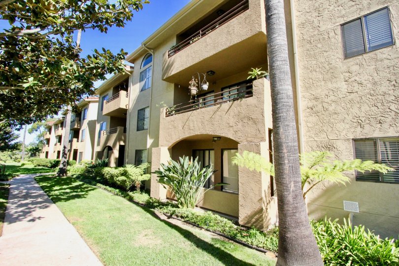 Sidewalk next to yard and condominiums inside Bernardo Greens in Rancho Bernardo CA
