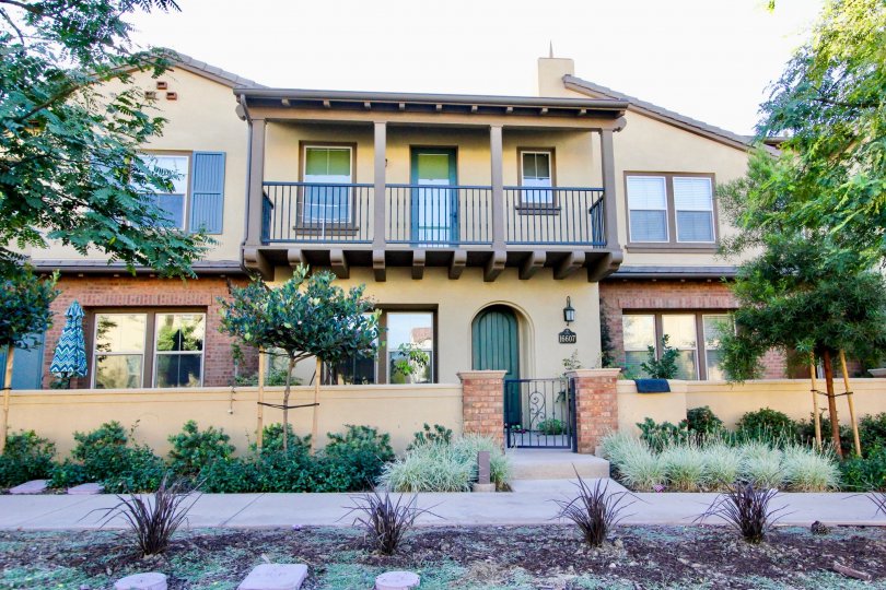 Two story building with green doors and metal railings at Mandolin in Rancho Bernardo California