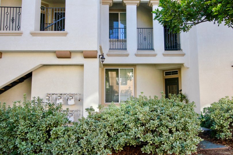 Two story housing with black railing and plants at Savannah Terrace in Rancho Bernardo California