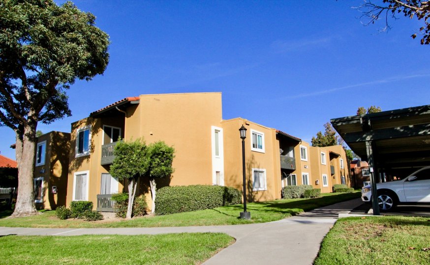 Two story brown housing with grass & parking inside Waterbridge in Rancho Bernardo CA