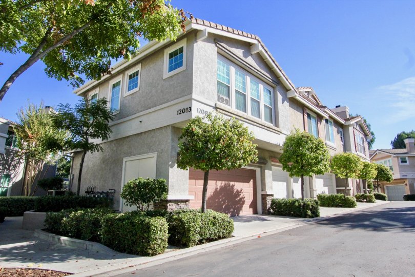 Gray homes with pink garage door near driveway at Windham in Rancho Bernardo California