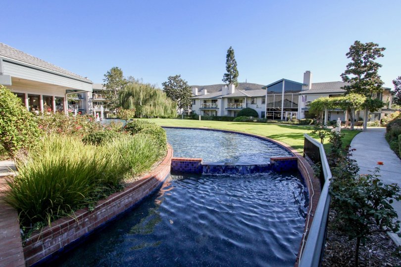 A man-made pond in the Chateau community surrounded by townhouses.