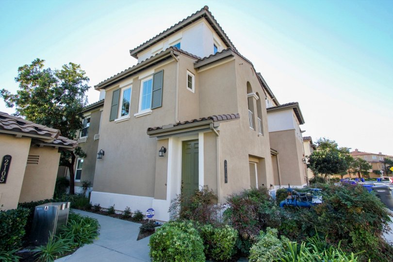 A three-storey townhouse painted in greenish and brownish hue in Larkspur Heights.