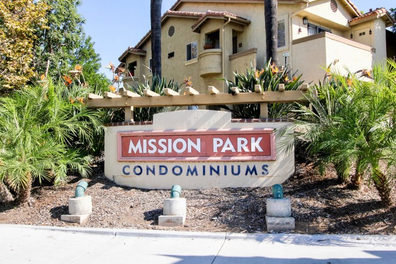 Red & white sign in front of a structure inside MIssion Park at San Marcos CA