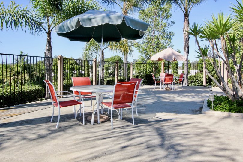 Four red & white chairs inside the Quail Country Villas in San Marcos CA