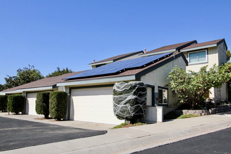 A bay of garages in front of a parking lot at Vallecitos Townhomes