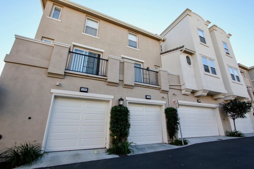 Village Square multi-story beige building with white garage doors San Marcos California