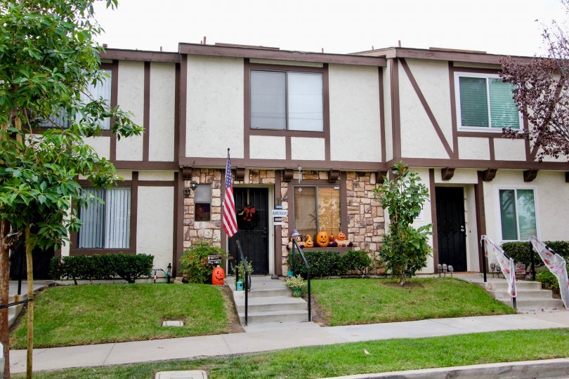 Town house in the Carlton Oaks Villas neighborhood on an overcast fall day, with Halloween decorations and American flag