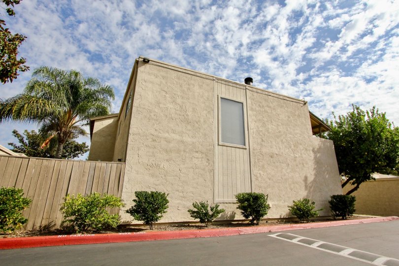 A sunny day in the area of Del Coronado Santee, parking lot, bushes, trees, cluds