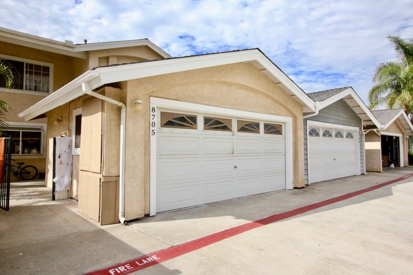 Double car garage parking units on a back lane with concrete paved backyards in Sunset Ridge