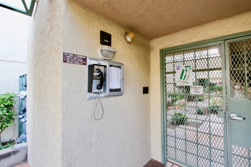 Near the gate of the Villa in La Jolla City Club has security phone with instruction board