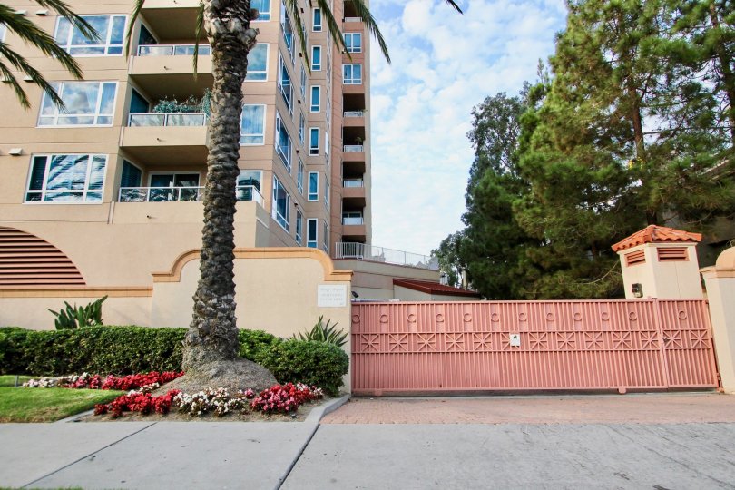 Large gated parking access with mature trees and shrubs for Pacific Regent La Jolla