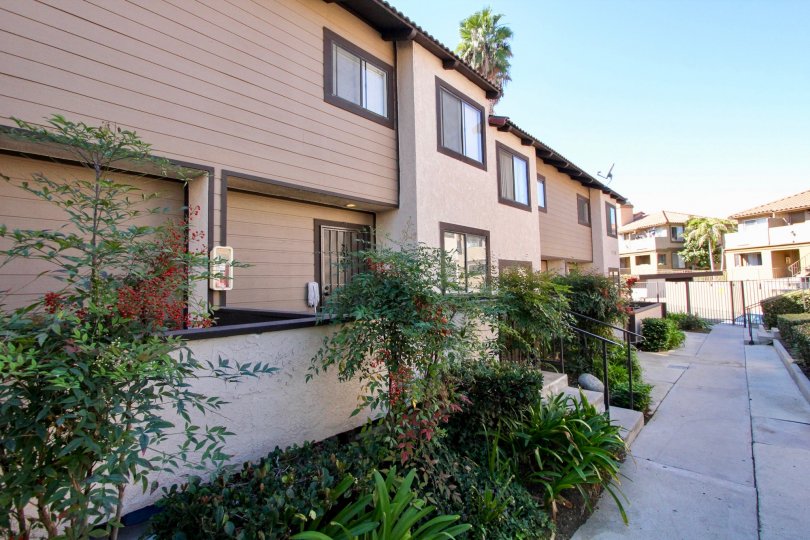Two story housing with garden plants at Buena Vista Townhomes in Vista California