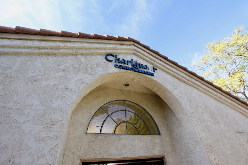 view of Charlemont condominiums entrance with blue sign and cream walls